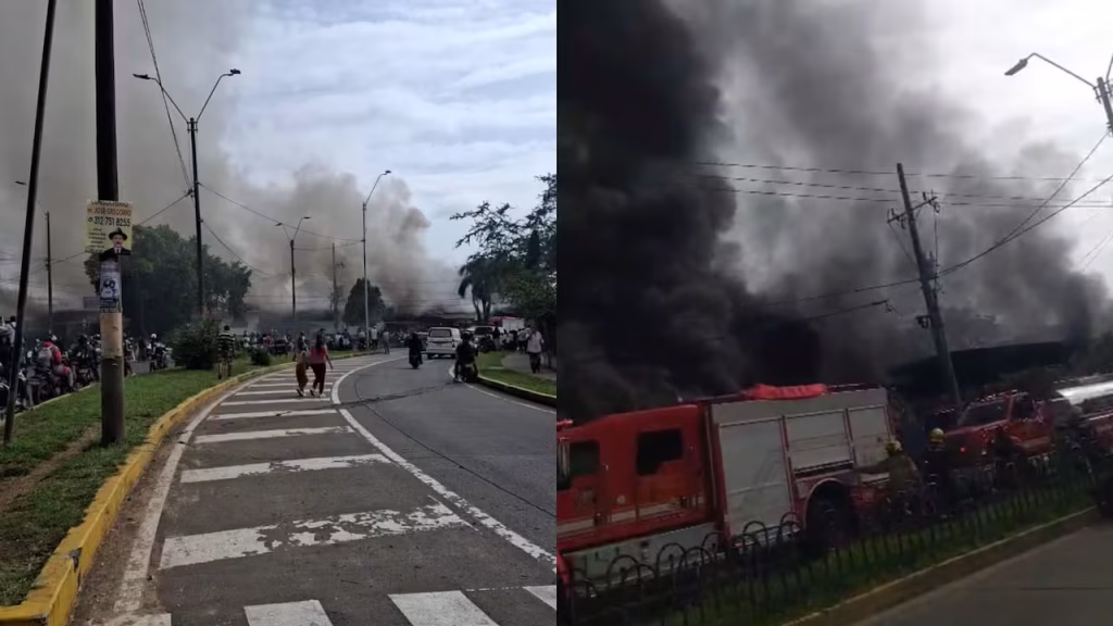 Bomberos trabajan para controlar un incendio estructural durante la Emergencia en Cali junto a la estación de Policía de El Lido.